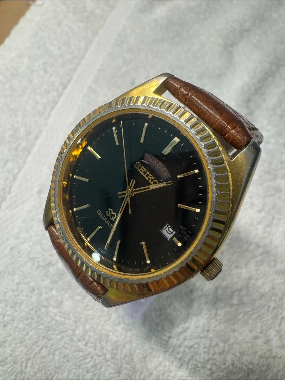 Seiko Black Dial Watch with Gold Accents and Brown Leather Strap